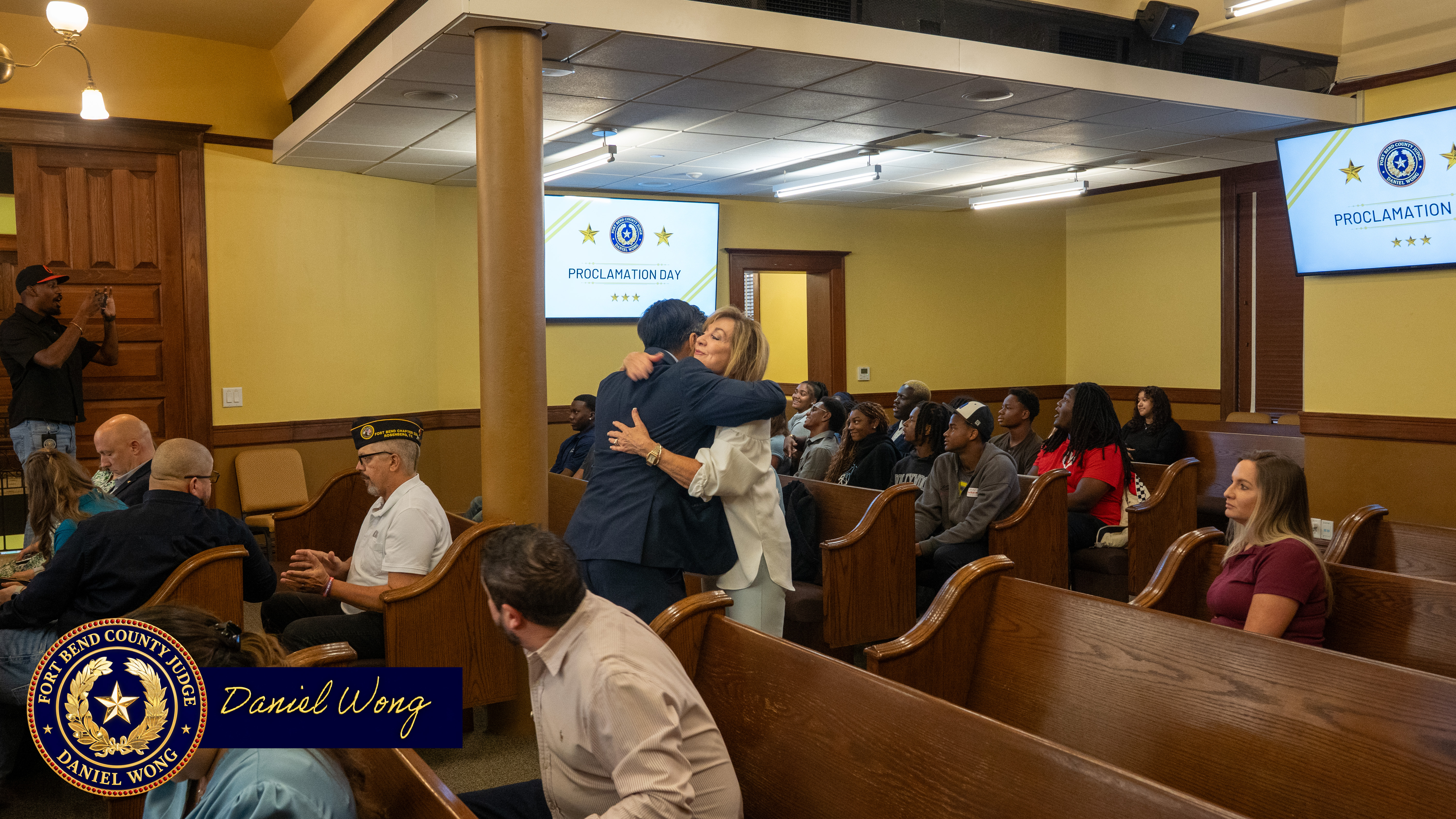 Sandy Mcgee hugs Fort Bend County Judge Dainel Wong