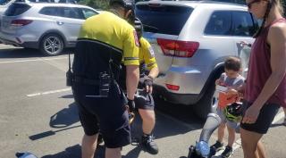 LT Ray and Paramedic Wynslow assisting with a youngster's bike