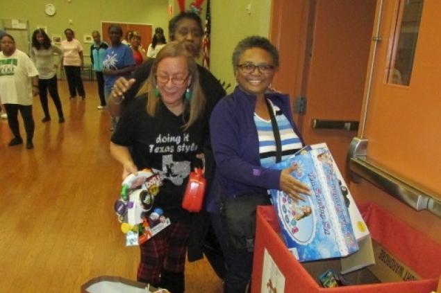 Line Dance Instructor and students donating toys.