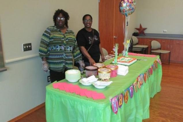 Patrons Serving May Birthday Cake Serving the May Birthday cake.