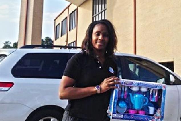 Teacher recieving toys Barbara Jordan International Pre School receives donations from the Line Dance Toy Drive